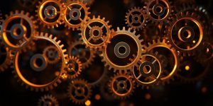 Glowing gears, interconnected, on a dark background.